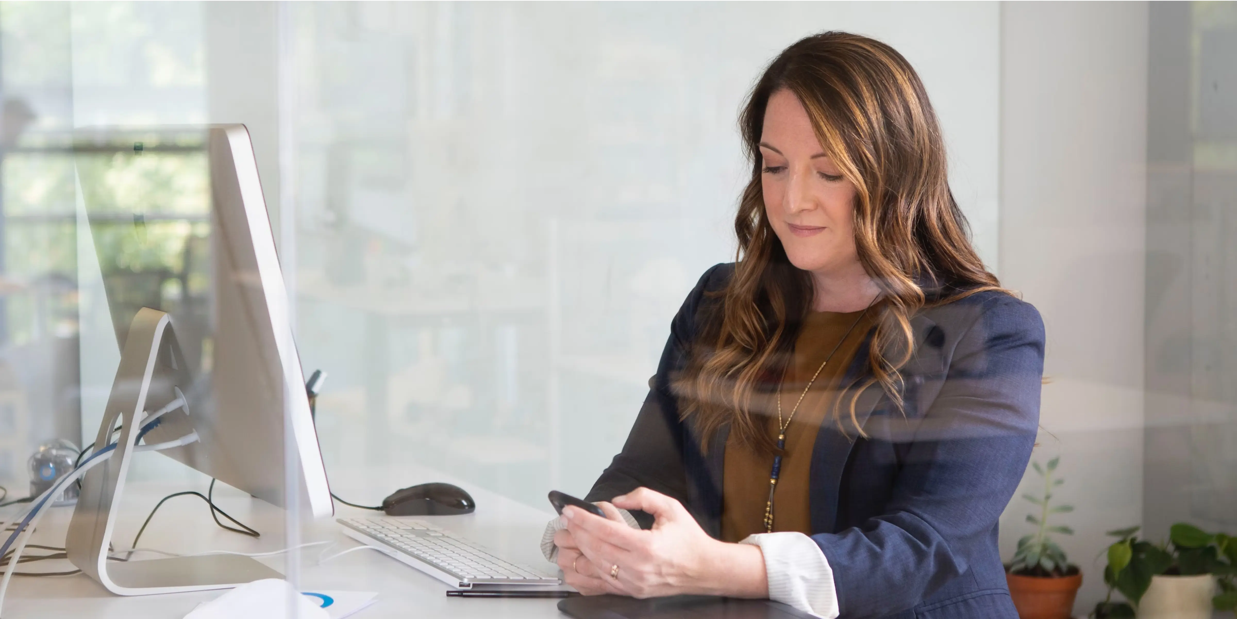 woman-using-cell-phone-and-computer