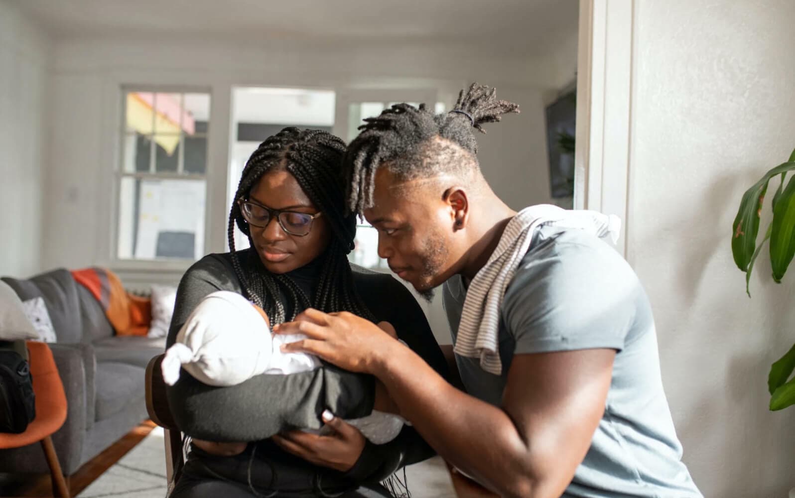 Two adults with an infant