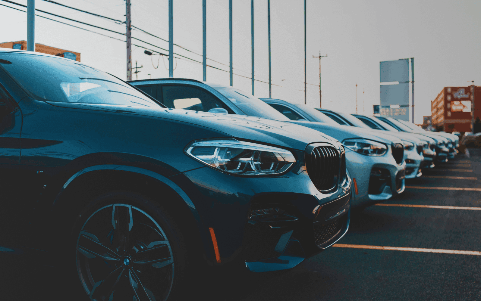 Cars parked side by side at a dealership
